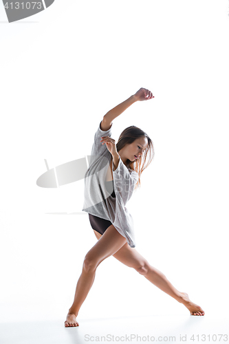 Image of Young beautiful dancer in beige dress dancing on white background