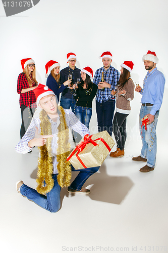 Image of Many young women and men drinking at christmas party