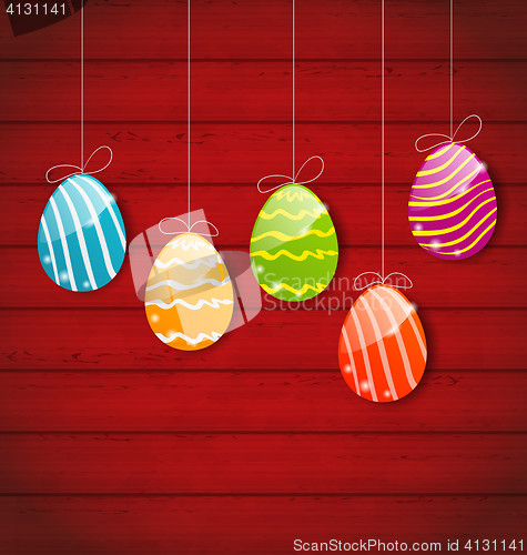 Image of Easter three ornamental colorful eggs on wooden background