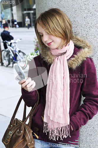 Image of Teenage girl text messaging on cell phone