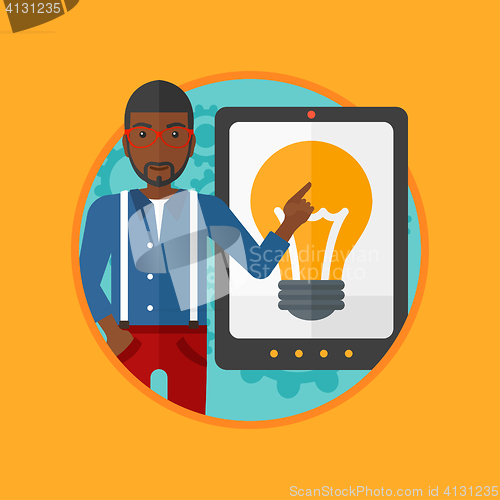 Image of Man pointing at big tablet computer.