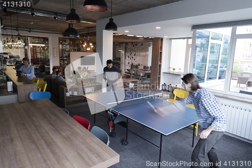 Image of playing ping pong tennis at creative office space