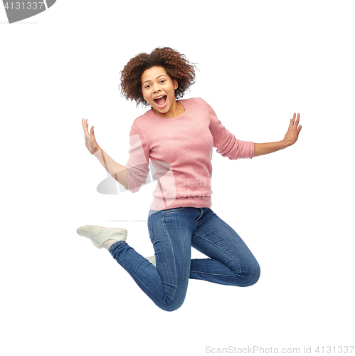 Image of happy african american woman jumping over white