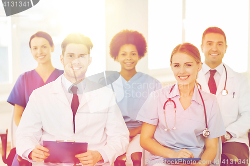 Image of group of happy doctors on seminar at hospital