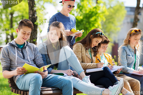 Image of group of students with notebooks at school yard