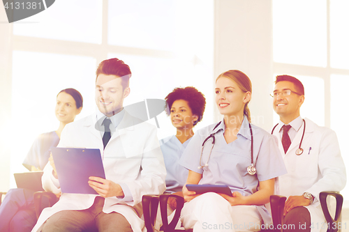 Image of group of happy doctors on seminar at hospital