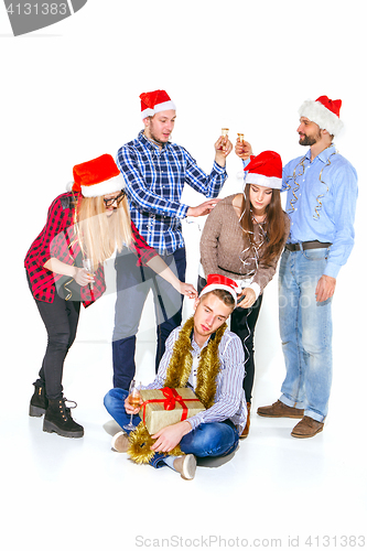 Image of Many young women and men drinking at christmas party