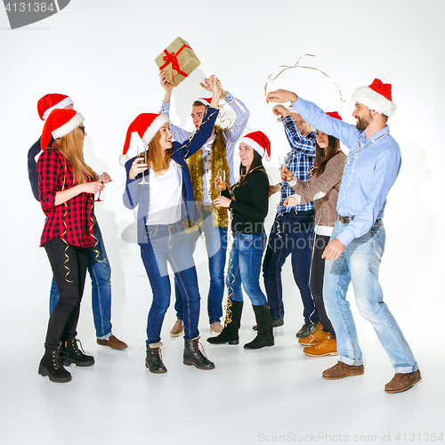 Image of Many young women and men drinking at christmas party