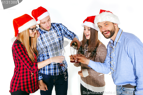 Image of Many young women and men drinking at christmas party