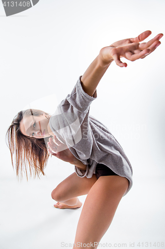 Image of Young beautiful dancer in beige dress dancing on white background