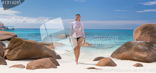 Image of Woman enjoying Anse Lazio picture perfect beach on Praslin Island, Seychelles.