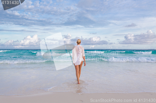 Image of Woman on summer vacations at tropical beach of Mahe Island, Seychelles.