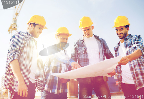 Image of group of builders with tablet pc and blueprint