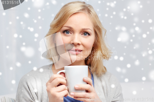 Image of woman with cup of tea or coffee at home