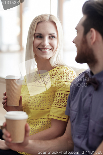 Image of happy man and woman drinking coffee in office
