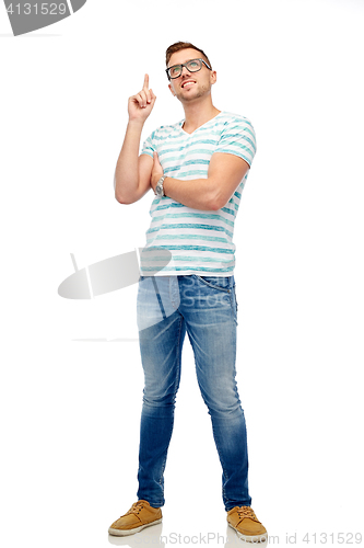 Image of happy young man pointing finger up