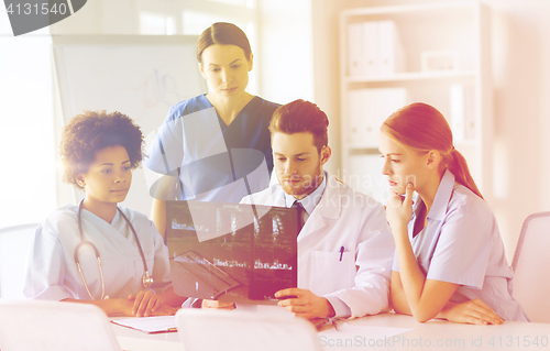 Image of group of doctors discussing x-ray image