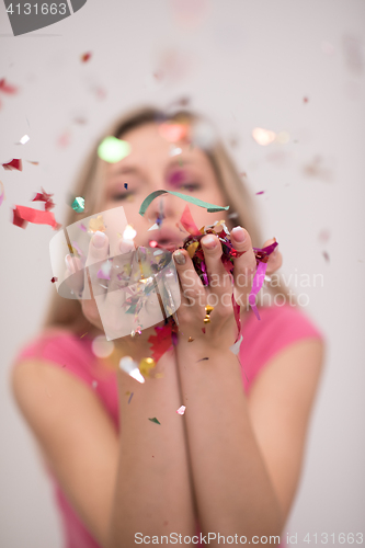 Image of woman blowing confetti in the air