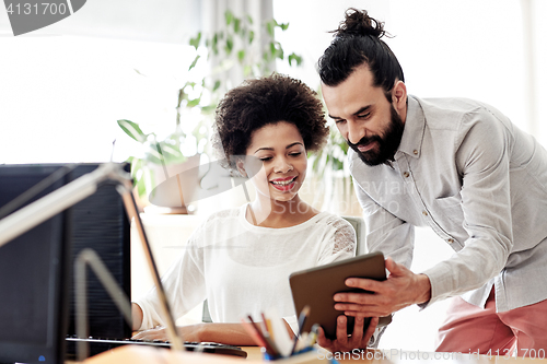 Image of happy creative team with tablet pc in office