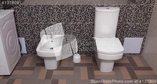 Image of white toilet bowl and bidet
