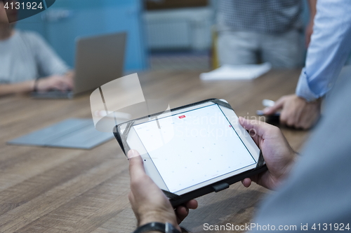 Image of close up of businessman on meeting using tablet