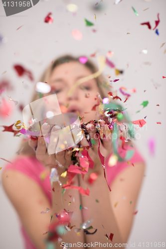 Image of woman blowing confetti in the air