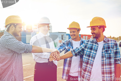 Image of builders and architects with hands on top