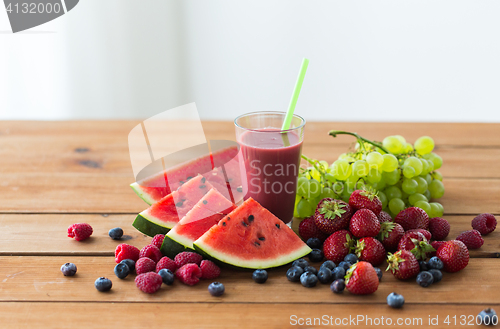 Image of fruit and berry juice or smoothie on wooden  table