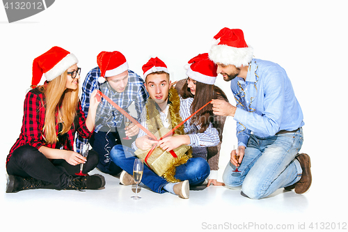 Image of Many young women and men drinking at christmas party