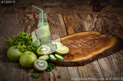 Image of The bottles with fresh vegetable juices on wooden table