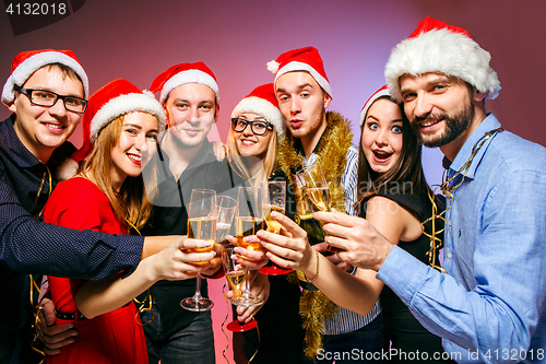 Image of Many young women and men drinking at christmas party