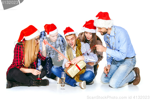 Image of Many young women and men drinking at christmas party