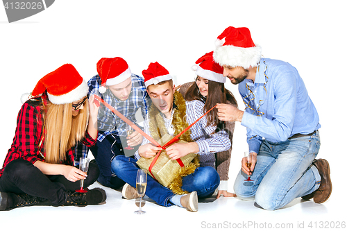 Image of Many young women and men drinking at christmas party