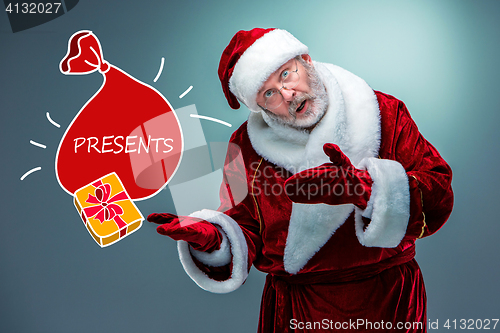 Image of Santa Claus, presenting something.