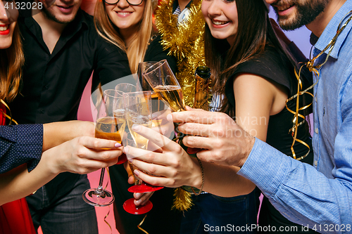 Image of Many young women and men drinking at christmas party