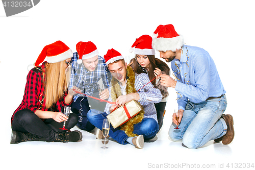 Image of Many young women and men drinking at christmas party