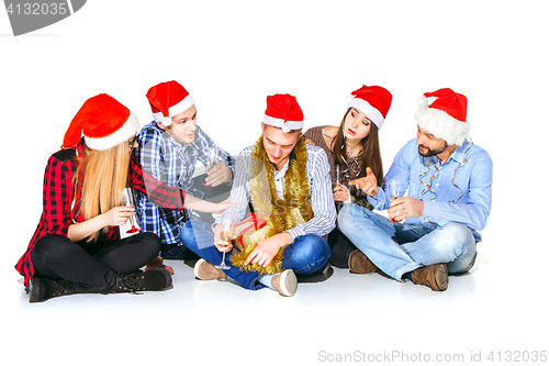 Image of Many young women and men drinking at christmas party