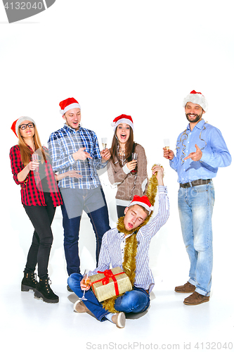 Image of Many young women and men drinking at christmas party