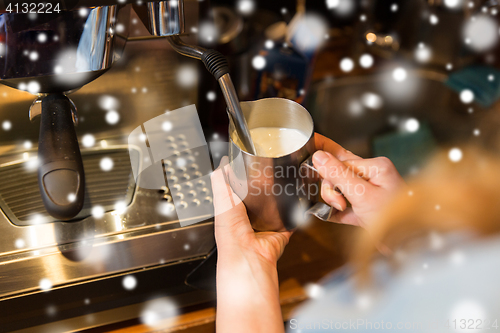 Image of close up of woman making coffee by machine at cafe