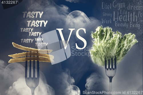 Image of Green lettuce leaves and French fries on a fork