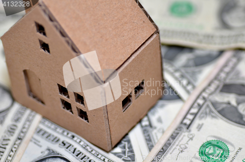 Image of Miniature paper made house stand on  money