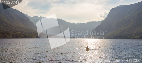 Image of Family rowing in canoe boat on beautiful lake Bohinj, Slovenia.