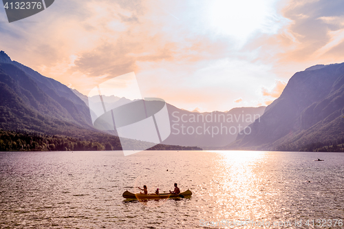 Image of Family rowing in canoe boat on beautiful lake Bohinj, Slovenia.