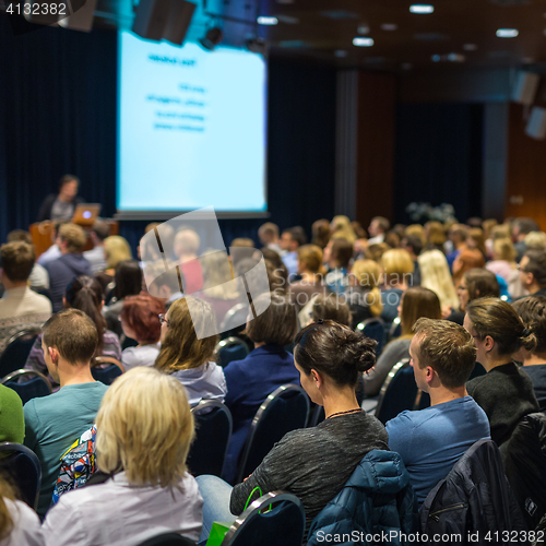 Image of Audience in lecture hall participating at business event.