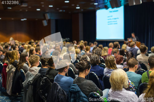 Image of Audience in lecture hall participating at business event.