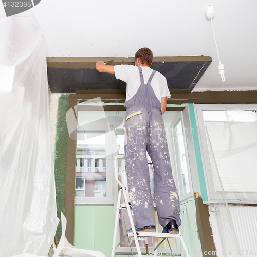 Image of Plasterer renovating indoor walls and ceilings. Finishing works.