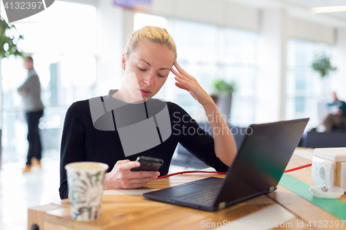 Image of Female freelancer remotely working on the go.