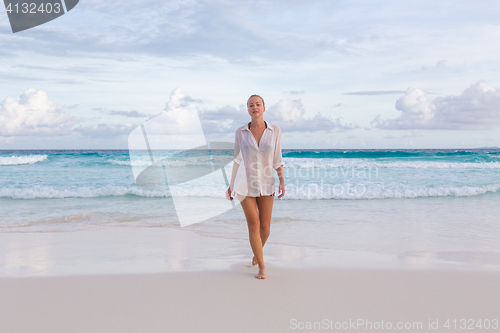 Image of Woman on summer vacations at tropical beach of Mahe Island, Seychelles.