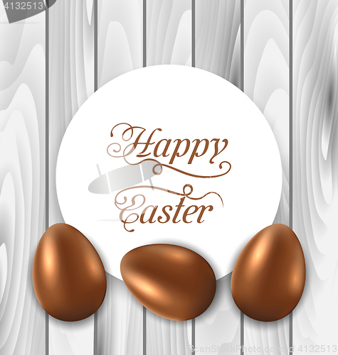 Image of Celebration card with Easter chocolate eggs on wooden grey backg