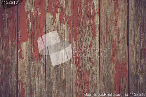Image of Red paint pealing off wooden planks